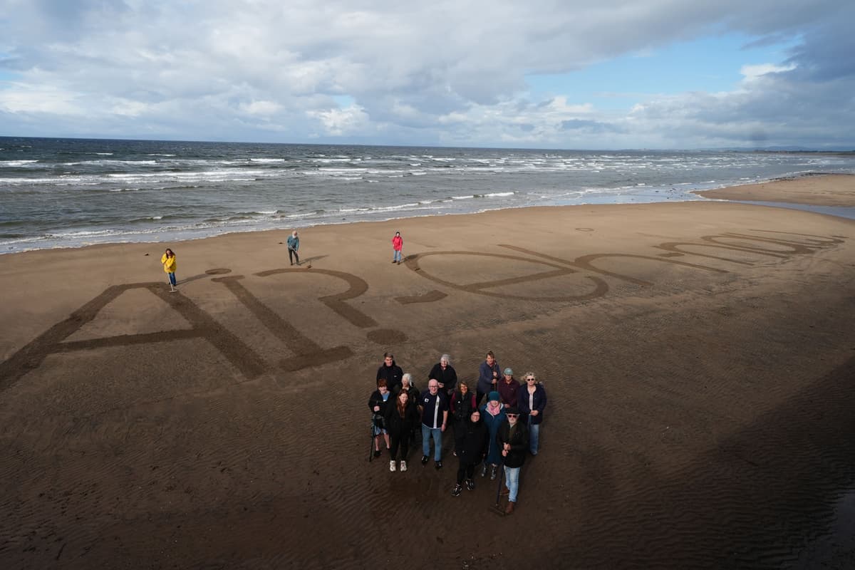 Activists write ‘naw’ to AI on beach as execs set to fly in for summit with King