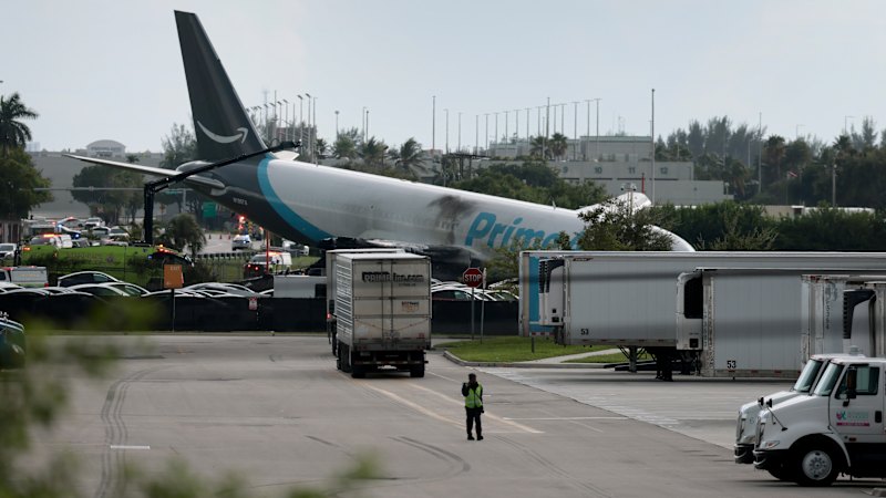 Amazon plane overruns runway, sending up cloud of smoke