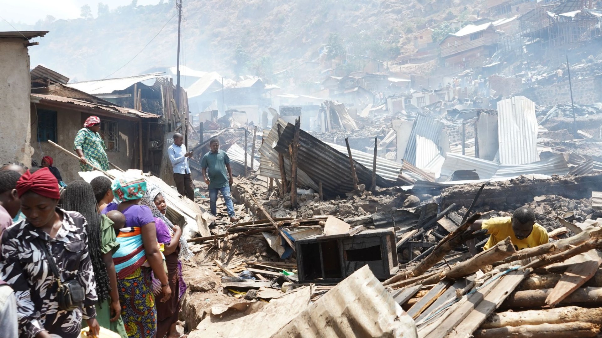 At least 24 children feared dead after fire ripped through school sparking stampede as 300 buildings destroyed by flames