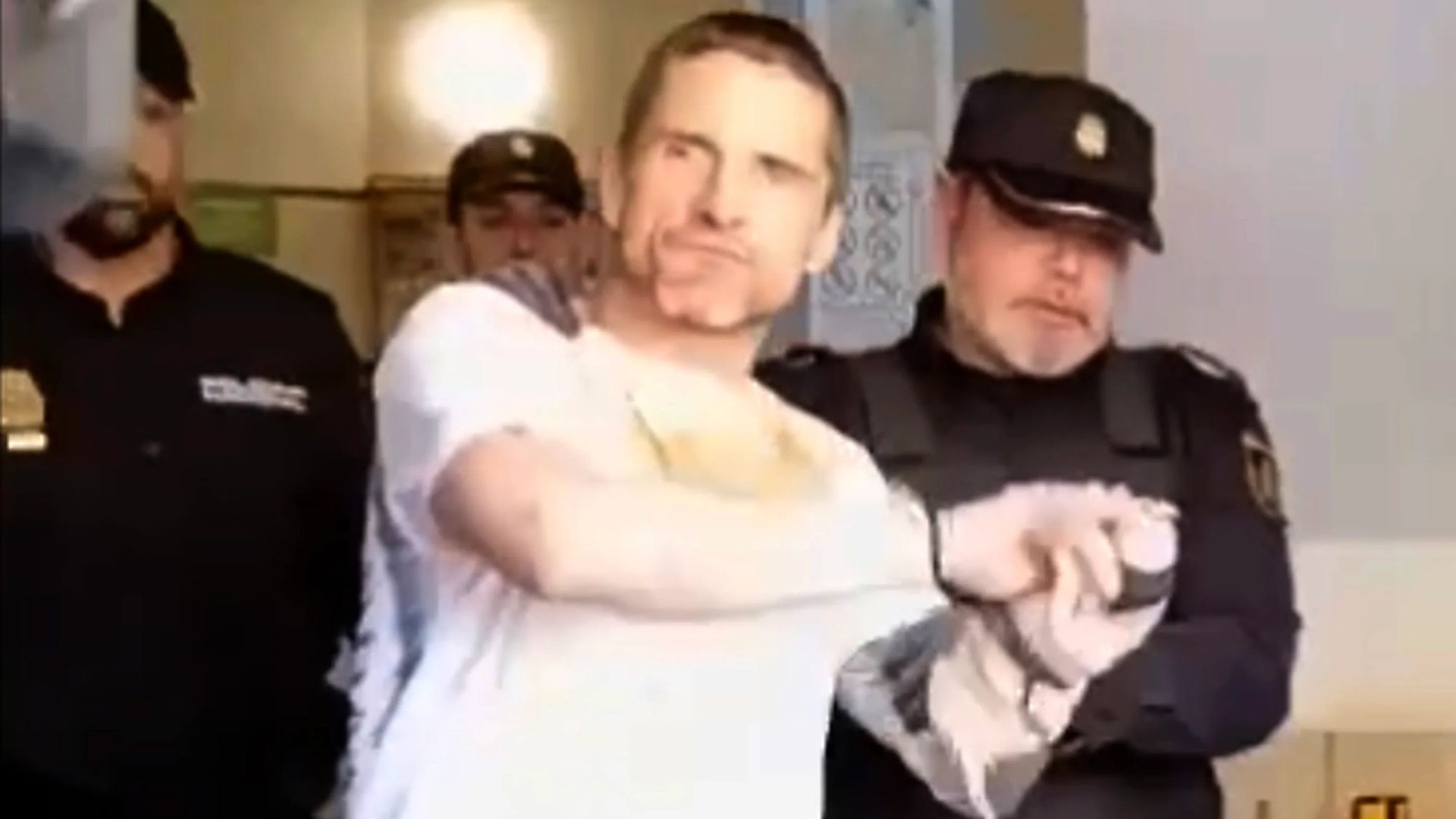 Handcuffed Brit shouts ‘f**k off’ as he & partner face 10 years in jail after ‘trying to kidnap woman’ on Spanish island