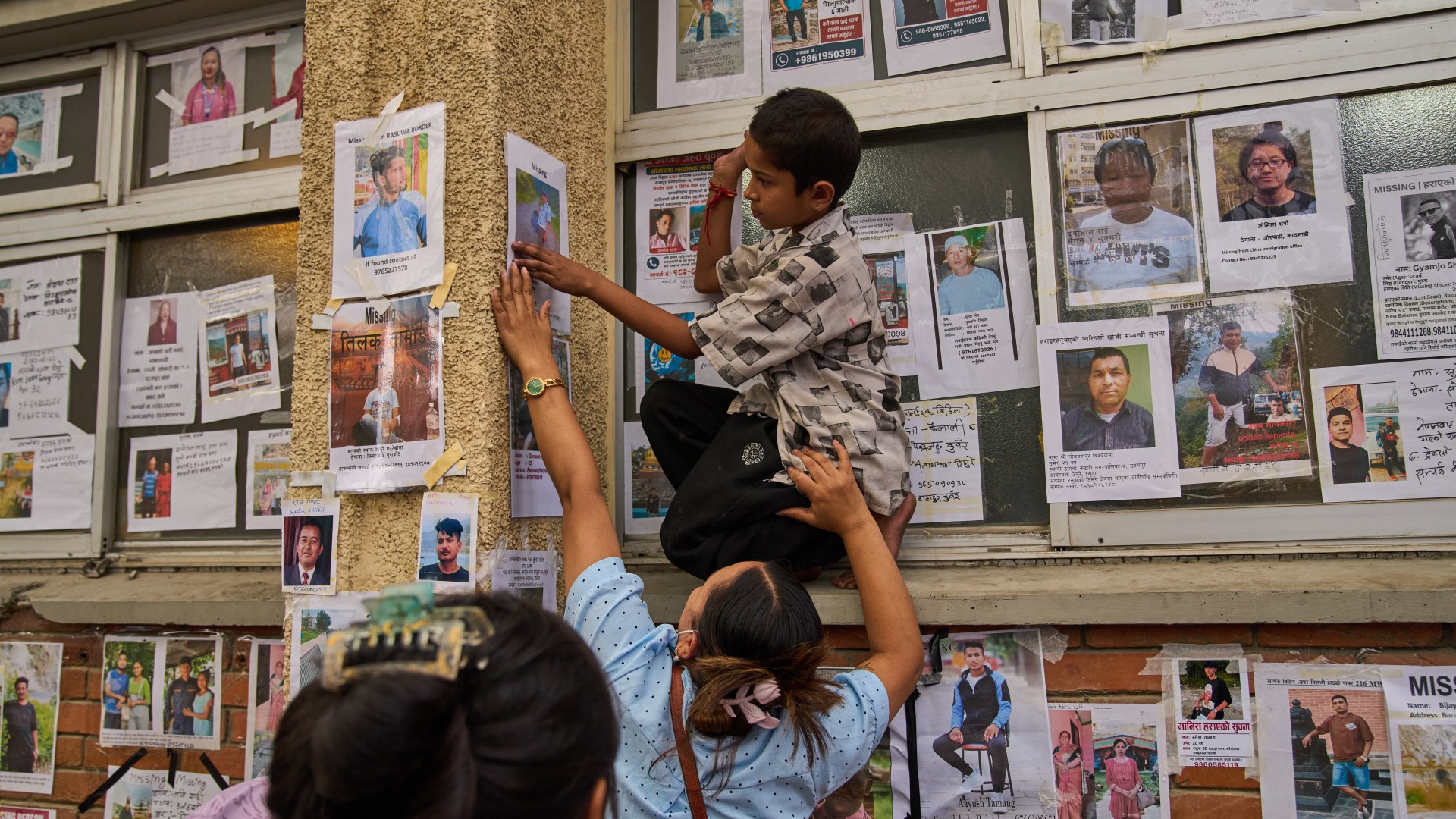 Harrowing photos of victims’ disfigured bodies line wall outside Nepal morgue as desperate families identify loved ones