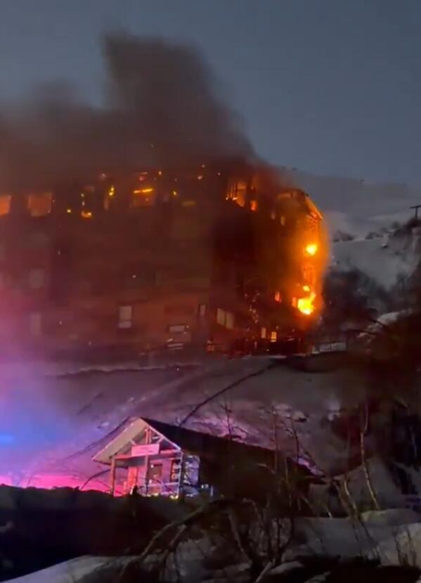 Horrifying moment hotel at ski resort goes up in flames as 150 terrified guests flee to escape raging inferno