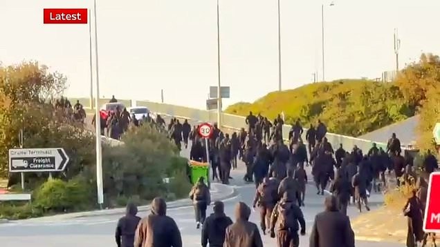 Hundreds of masked people in balaclavas halt traffic in Dover as part of protest