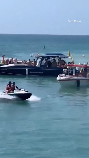 Jet ski sends holidaymakers flying after slamming into sightseeing boat in popular tourist spot