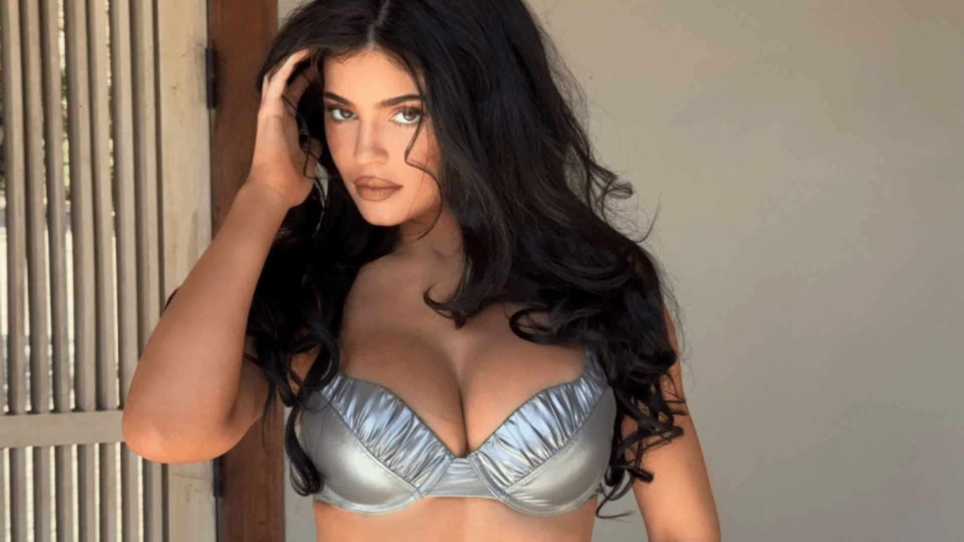 Kylie Jenner bursts out of tiny silver bikini to announce Khy swimsuit sale