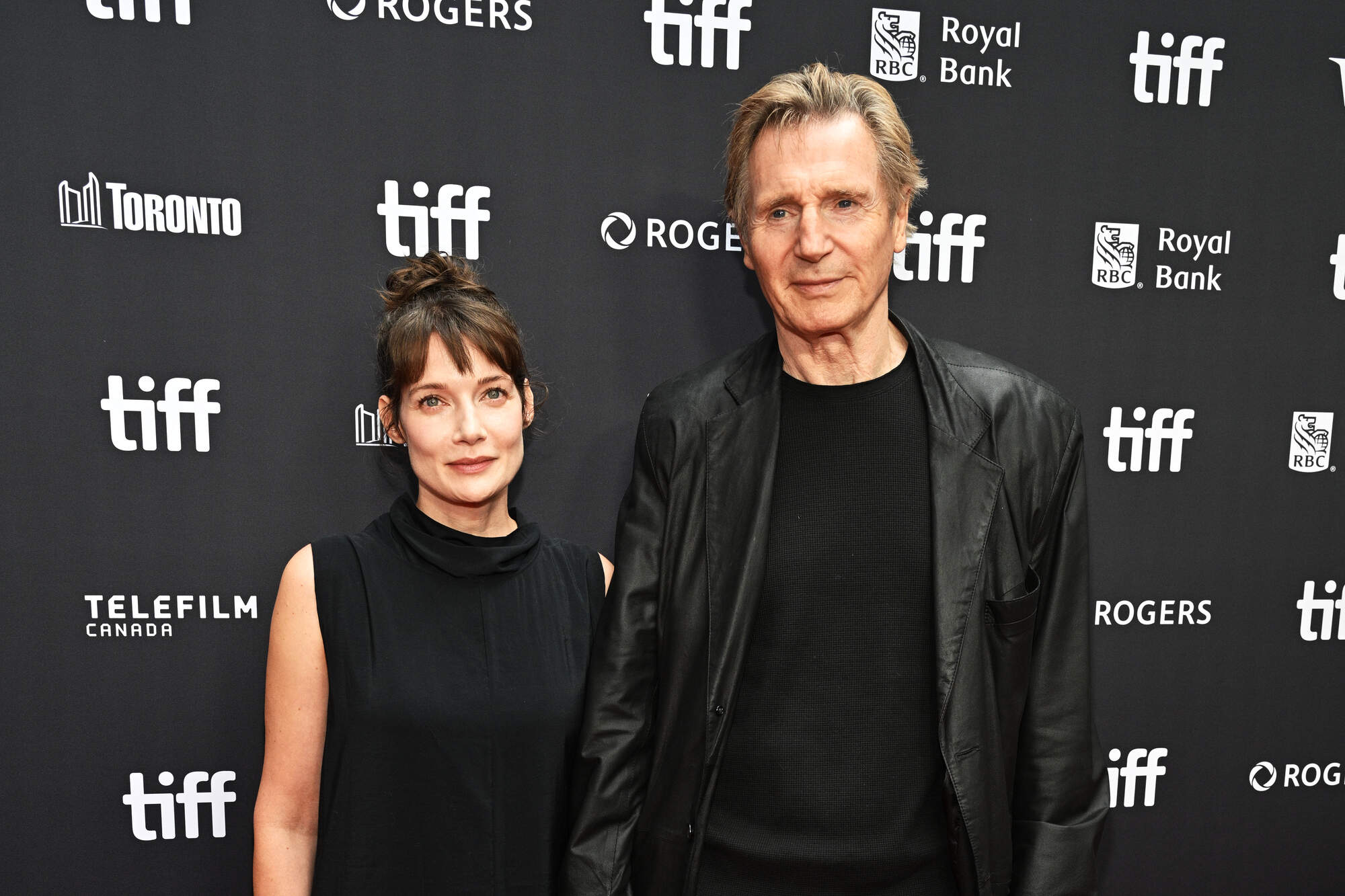 Liam Neeson pictured holding hands with co-star Stella Stocker at film festival red carpet