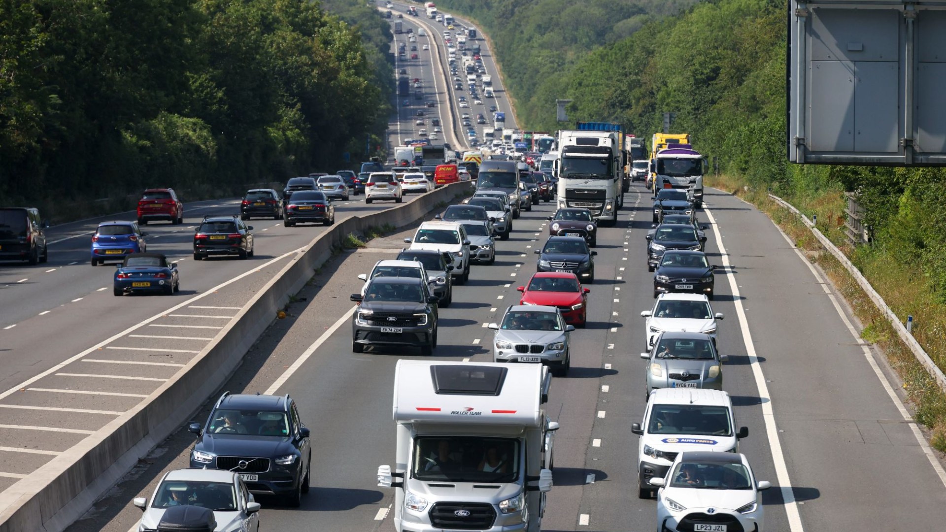 M3 closed after lorry ploughs into central reservation & spills 300 litres of diesel – as road to remain shut for hours
