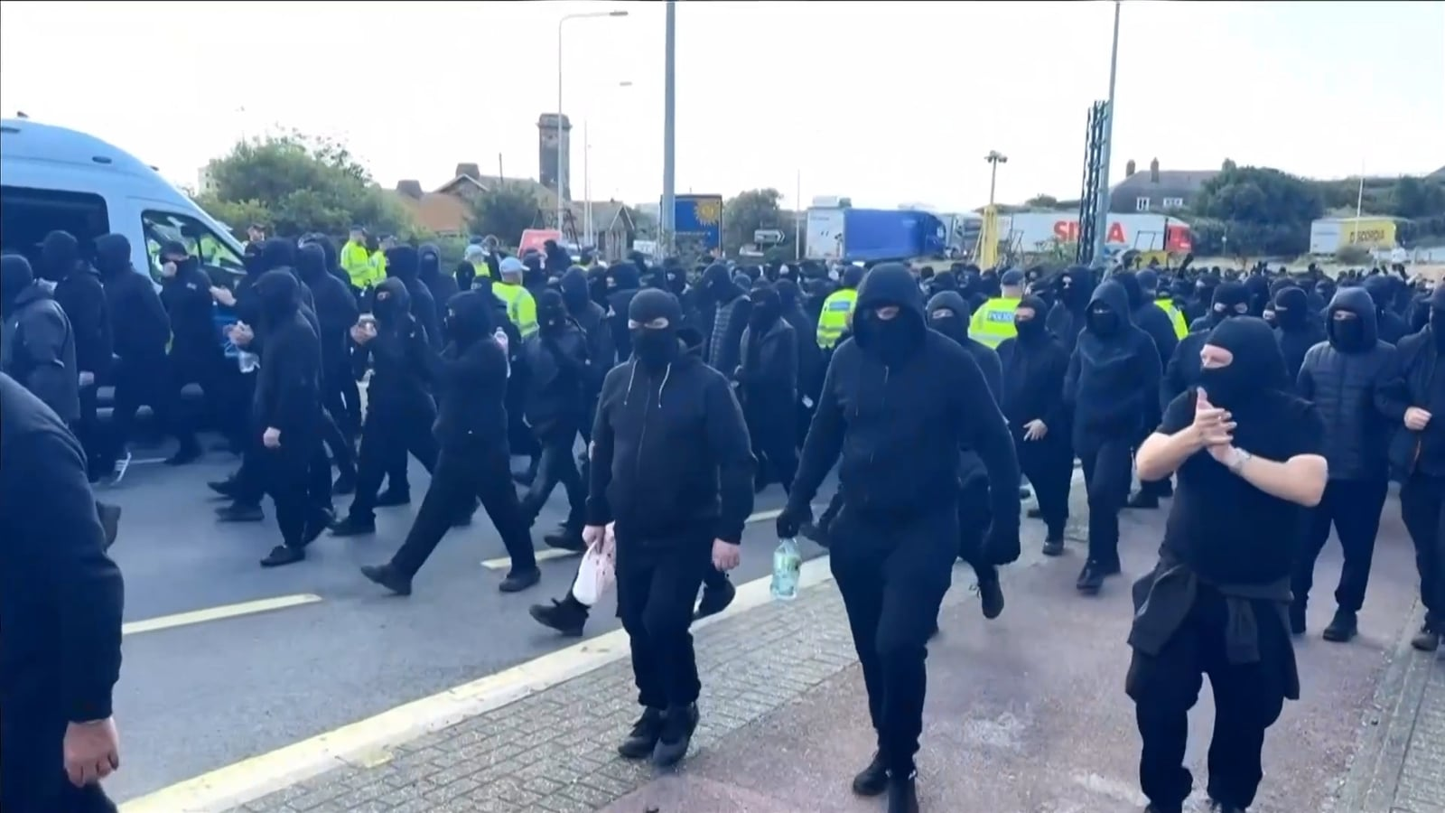 Masked protesters hold 'anti-illegal migrant' demo in UK