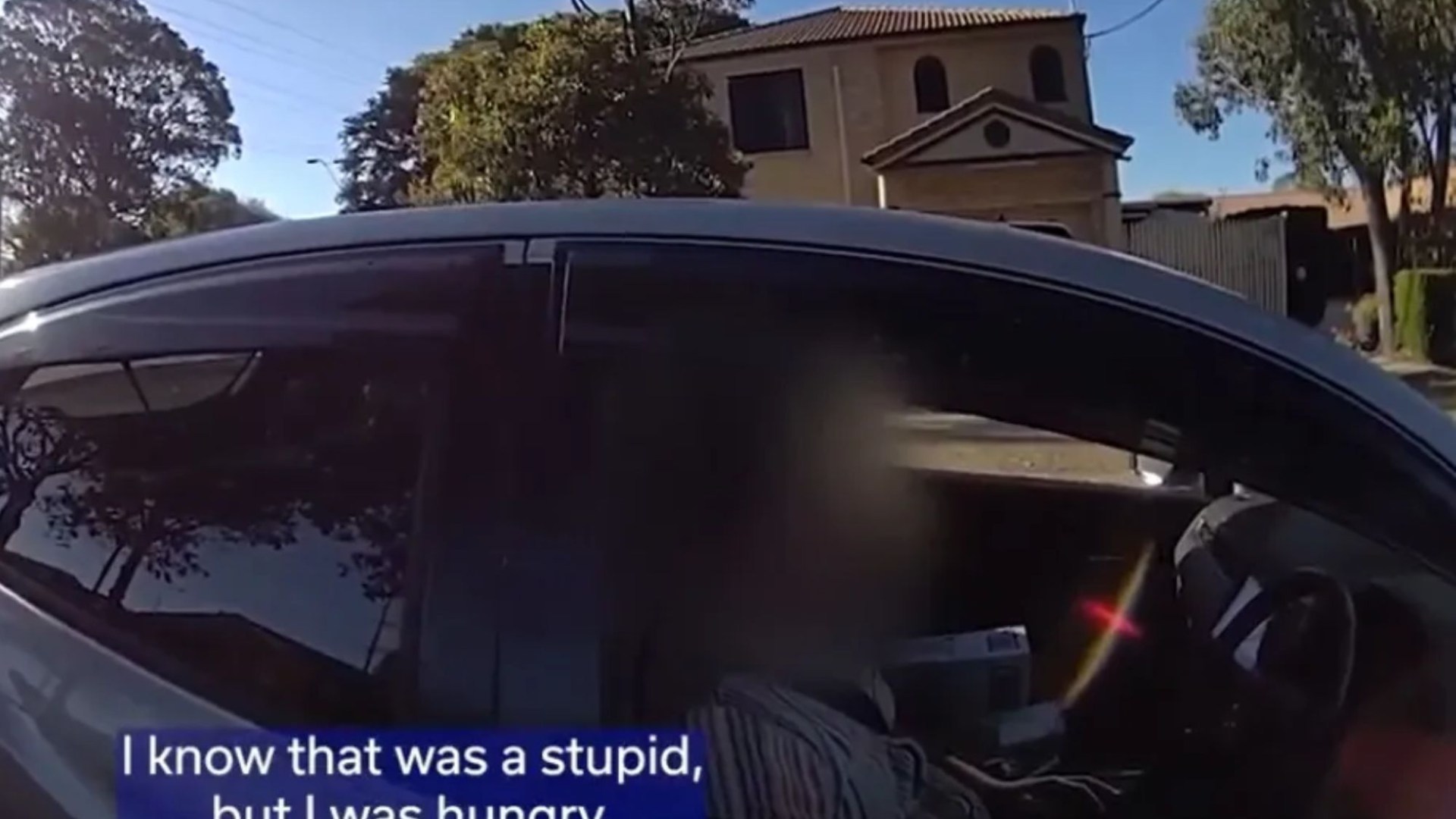 Moment driver pulled over by cops after being caught ‘buttering bagel while driving with his knees’ in heavy traffic