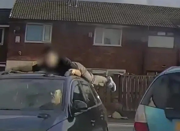 Moment teen yells ‘help’ as he’s dragged along on roof of car after driver tried to escape hit-and-run crash
