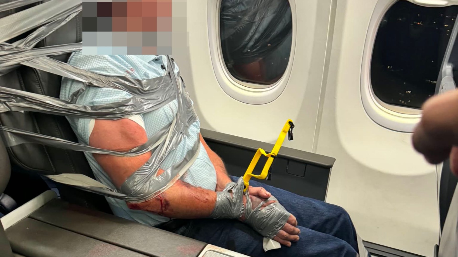 Moment unruly passenger gets duct-taped in seat after ‘hurling abuse at crew’ in midair meltdown forcing plane to divert