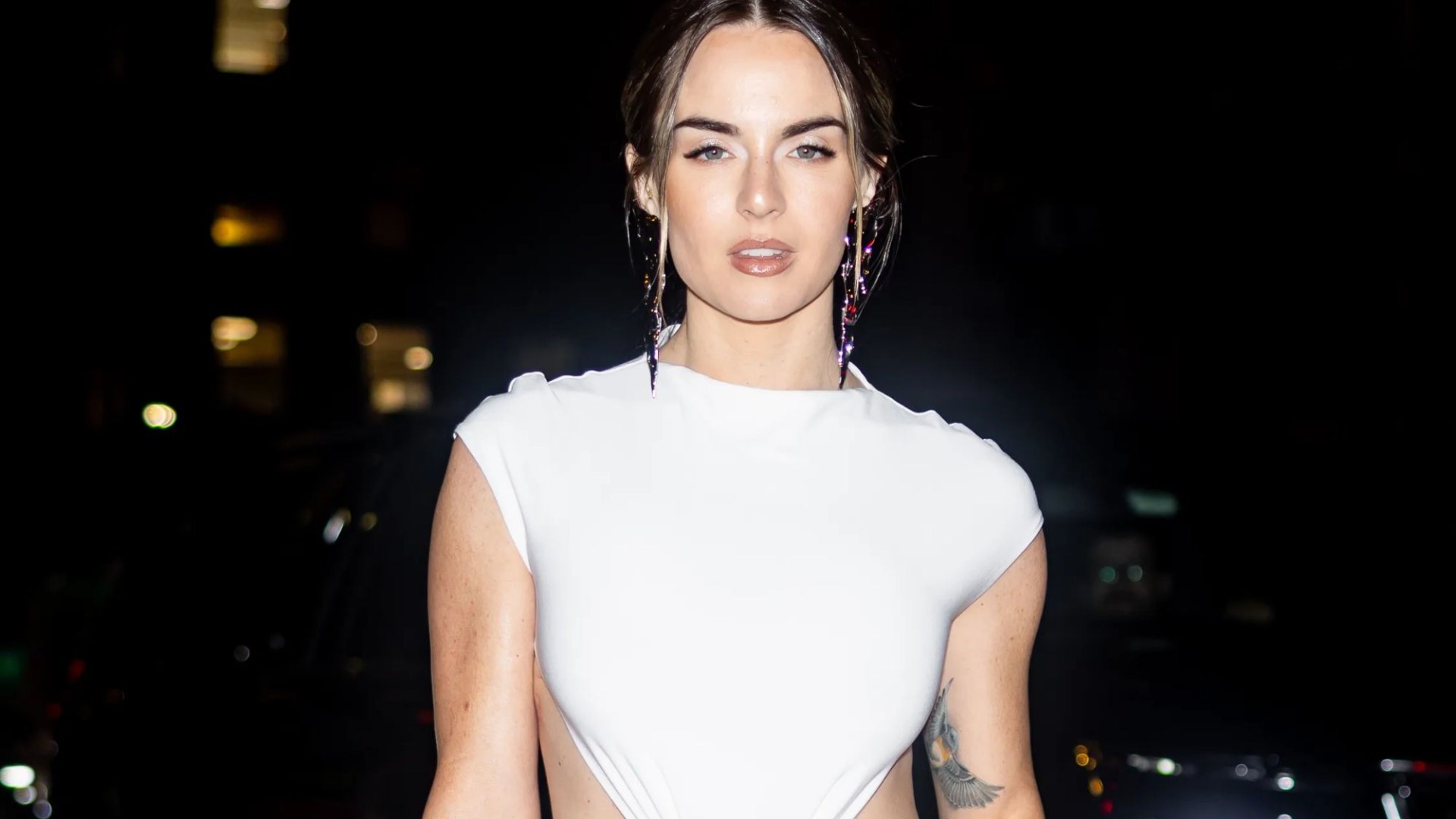 Noughties pop star looks unrecognisable as she flashes toned tum & tattoos at New York Fashion Week – can you guess who?