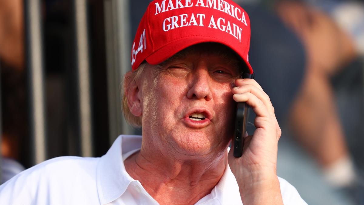 Nvidia CEO Jensen Huang puts President Donald Trump on phone while downplaying AI risks