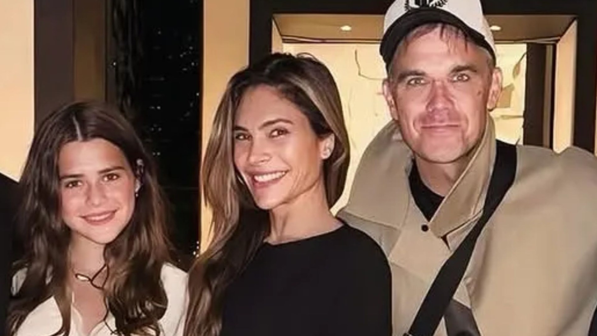 Proud parents Robbie Williams and Ayda Field beam beside daughter Teddy, 13, in a rare family snap in Paris