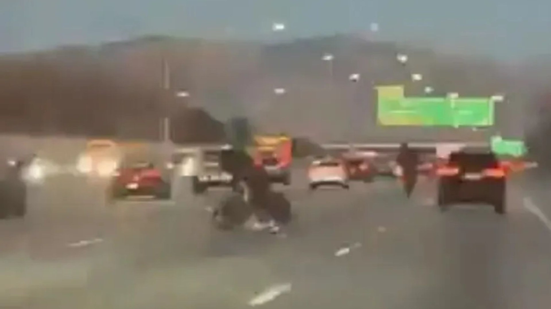 Shocking moment two motorcyclists perform dangerous stunt in middle of busy highway and get instant karma