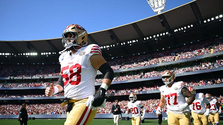 Sold out Melbourne crowd stands for 25th anniversary commemoration of 9/11 at NFL's first Australia game