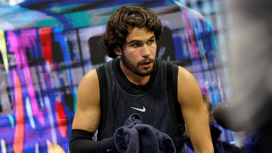 Tennis star Carlos Alcaraz vomits in towel during US Open thriller after trying to shoo cameras away