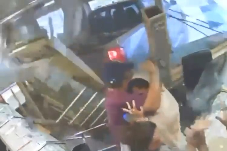 Terrifying moment jewellers is ram-raided by sword-wielding thugs before hero owner fights them off with baseball bat